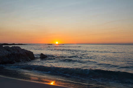 The sun rising up in Cala Ginepro in Sardinia next to Bidderosa, Italyの写真素材