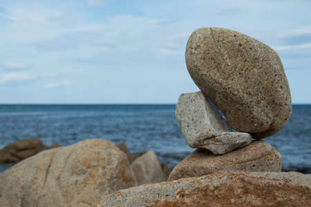 Some rocks standing in balance by the seaの写真素材