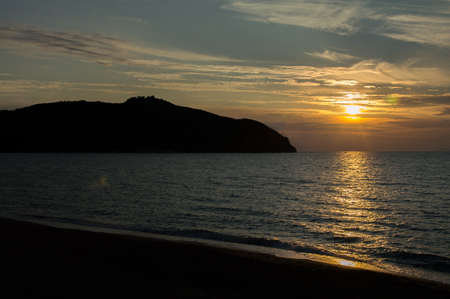 a beautiful view of the baratti gulf at sunsetの写真素材