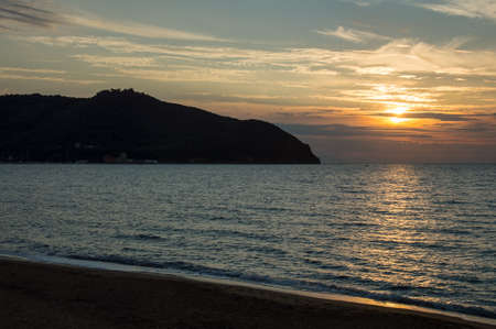 a beautiful view of the baratti gulf at sunsetの写真素材