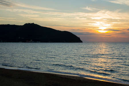a beautiful view of the baratti gulf at sunsetの写真素材