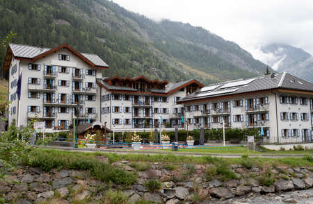 Typical Swiss architectural landscape with the mountains behindの写真素材