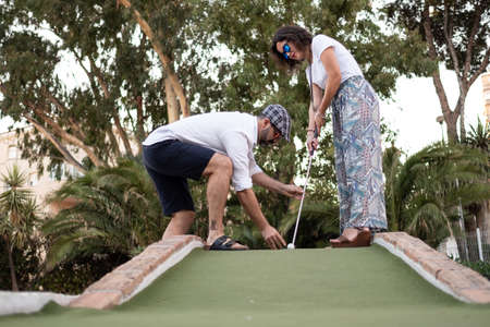 man giving golf lesson to womanの写真素材