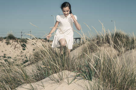 girl playing and laughing among wheatの写真素材