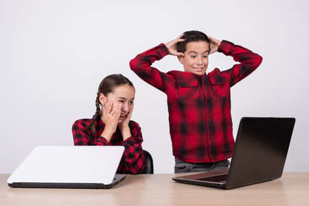 surprised children in class looking at a computerの写真素材