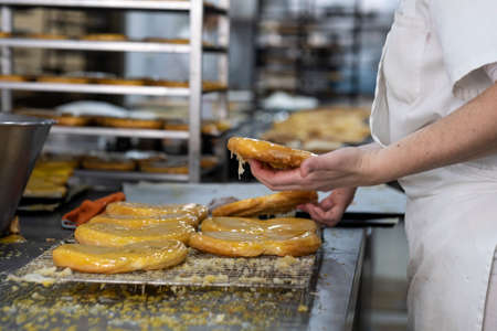 artisan pastry chef placing cake on trayの写真素材