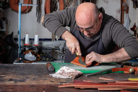 craftsman working the leather in his small workshop
