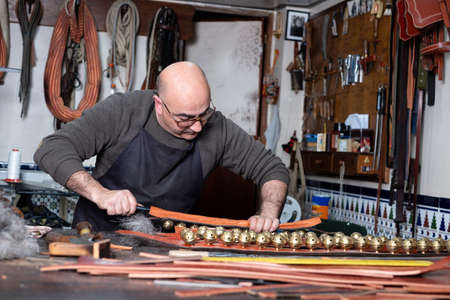 craftsman working the leather in his small workshop