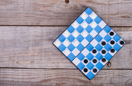 small checkers game on a blue board