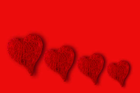 hearts of different sizes on a red background. Concept of St. Valentine's Dayの写真素材