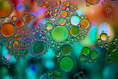 Abstract background with vibrant colors. Oil drops in water. Close colorful and artistic bubbles. Space pattern.の写真素材