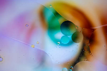 Abstract background with vibrant colors. Oil drops in water. Close colorful and artistic bubbles....