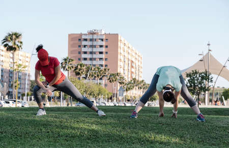 girls doing stretching exercises in the park