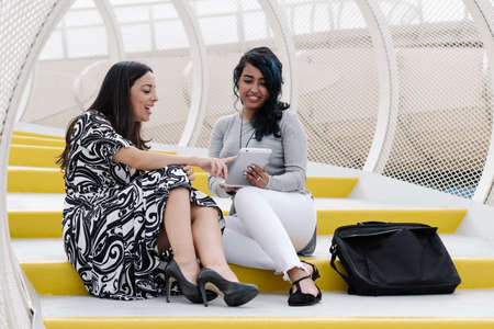 business women looking at a tablet and having a conversationの写真素材