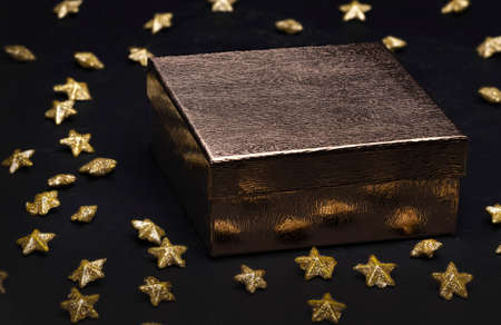 gift box with Christmas decoration of gold stars with glitter