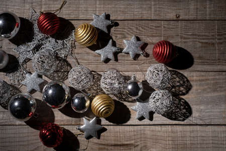 christmas decoration with balls and stars on a wooden background