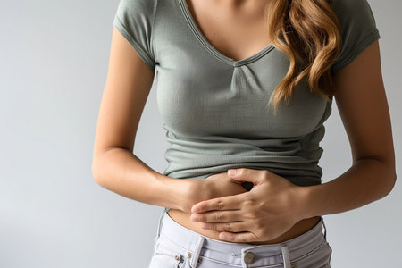 Woman with Stomach Pain Holding Abdomen, Concept of Digestive Discomfort or Illnessの素材