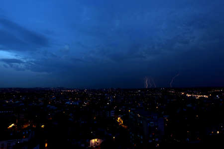 Multiple lightning strikes over a big city by night - in Belgrade, Serbiaの写真素材