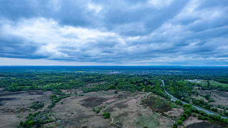 Aerial view of rural landscape with fields and meadows under cloudy skyの写真素材