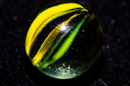 Close-up of a colorful crystal ball on a black background.の写真素材