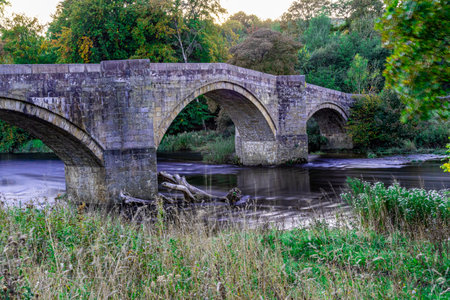 Old stone bridge over the river in the countryside of England, UKの写真素材