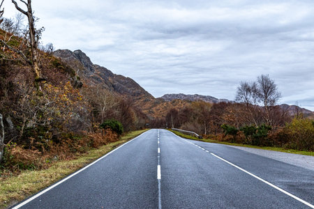 Asphalt road in the mountains. Beautiful landscape of Scotland nature.の写真素材