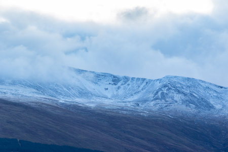 Snowy mountains in the clouds. Snowy landscape in the mountains.の写真素材