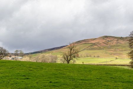 A view of the English Lake District under a cloudy sky in winter