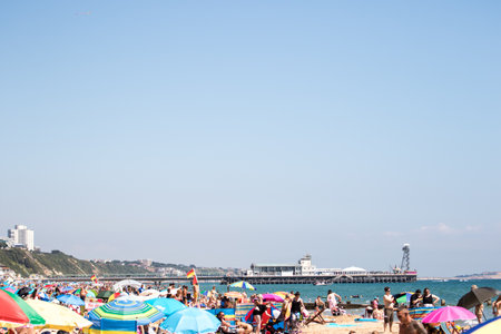 People sunbathe on the beach in Barcelona, Spainの写真素材