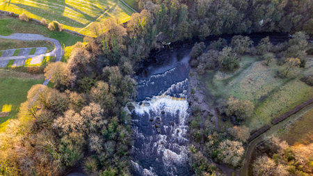 Aerial view of the waterfall in the middle of the forest.の写真素材