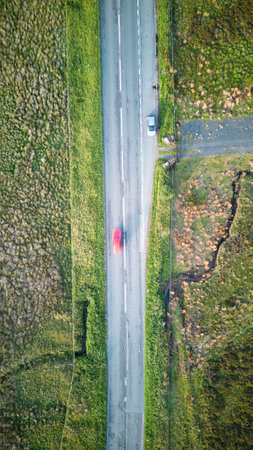 Aerial view of a red car on a road in the countrysideの写真素材