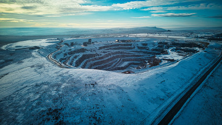 Aerial view of a road in the middle of a snow covered fieldの写真素材