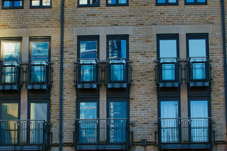 Modern apartment building facade with symmetrical windows and balconies, urban architecture background in Harrogate, England.の写真素材