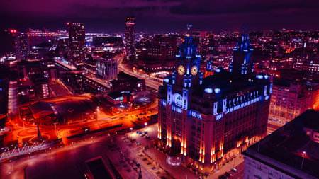 Night cityscape with illuminated buildings and streets, showcasing urban architecture and vibrant...
