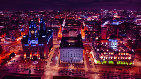 Aerial night view of a vibrant cityscape with illuminated buildings and streets in Liverpool, UK.の写真素材