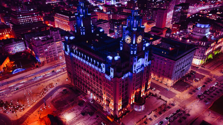 Aerial night view of an illuminated historic building in an urban setting with city lights in Liverpool, UK.の写真素材