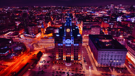 Aerial night view of a cityscape with illuminated buildings and streets, showcasing urban architecture and vibrant city life in Liverpool, UK.の写真素材