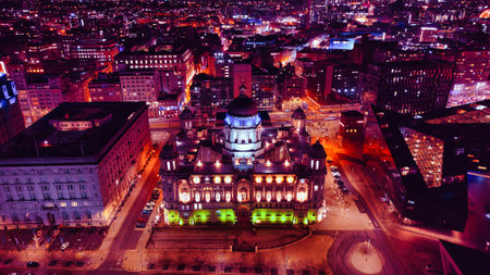 Aerial night view of an illuminated cityscape with historic architecture in Liverpool, UK.の写真素材