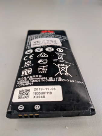Malaysia, Kuala Terengganu 20 Disember 2020 : an inflatable Huawei brand smartphone battery and dangerous to use. Selective focus.のeditorial素材