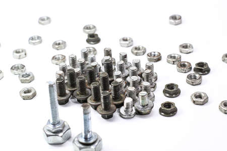 creative screw and nut arrangement with white background. Selective focus.の写真素材
