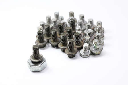 creative screw and nut arrangement with white background. Selective focus.