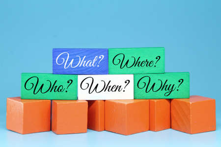 colored cubes with the words what where who when why. business concept