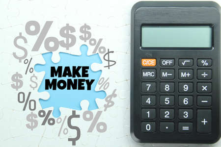 calculator, white puzzle, with the word make money