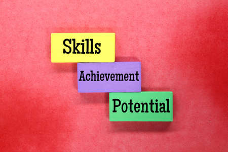 colored cubes with the words skills, achievement and potentialの写真素材
