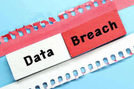 torn paper, colored boards with the word data breach