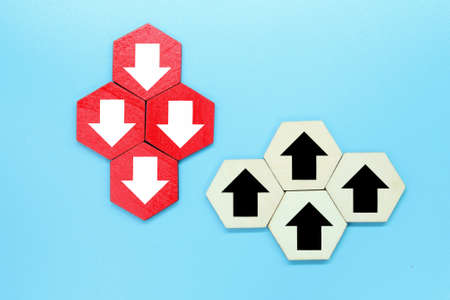 colored wooden hexagons with down and up arrowsの写真素材