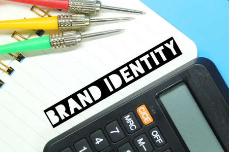 arrows, notebooks, calculators with the word brand identityの写真素材