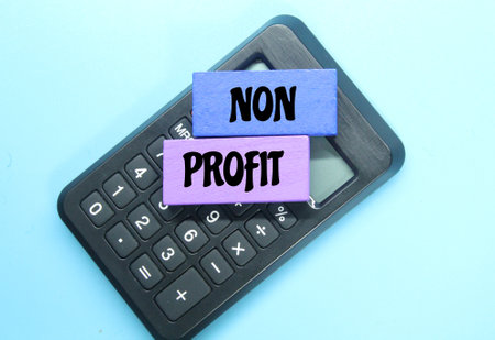 calculator, colored board with the word non profitの写真素材