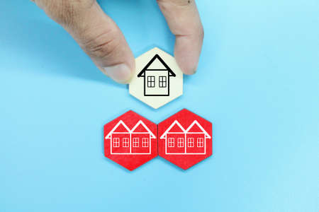 hexagon with a finger select the desired house. the concept of real estateの写真素材