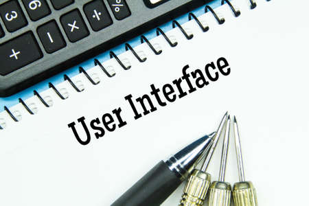 calculator, notebook, pen, arrows with words user interfaceの写真素材